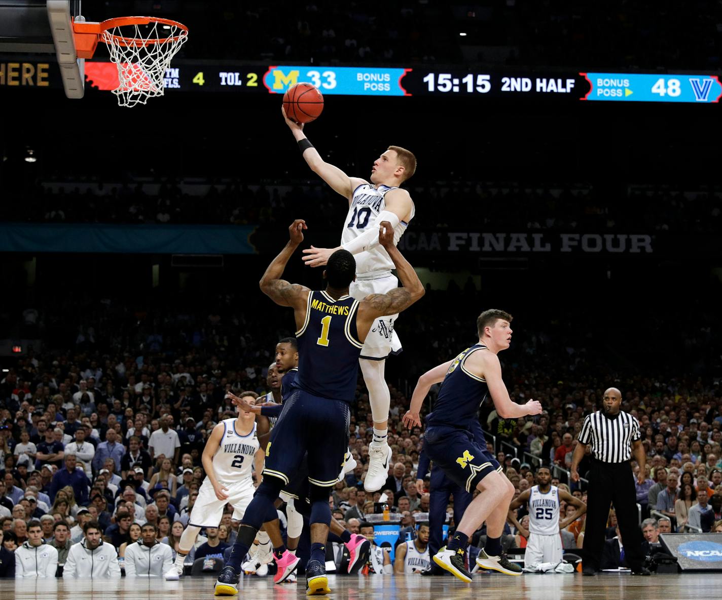 Villanova guard Donte DiVincenzo drives to the basket over Michigan guard Charles Matthews (1) during the second half in the championship game of the Final Four NCAA college basketball tournament, Monday, April 2, 2018, in San Antonio. (AP Photo/David J. Phillip)