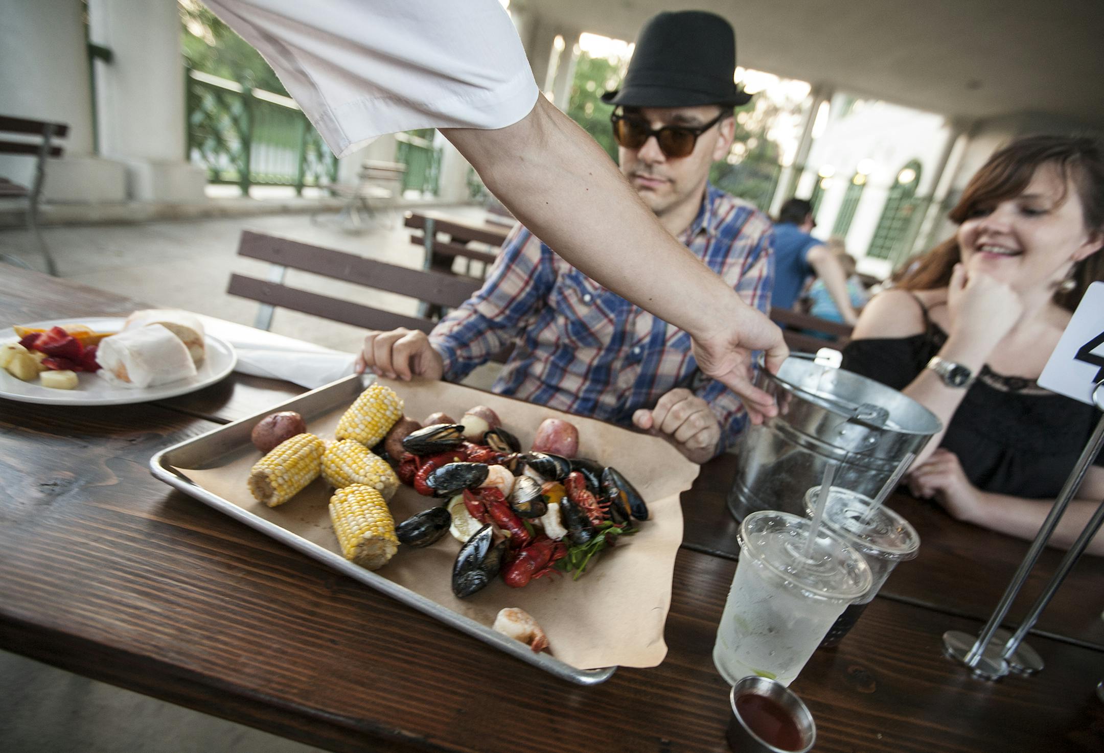 The Seafood Boil is poured out of a bucket for Matt Rolfe and Brandy Fritz of Plymouth at Como Dockside in St. Paul September 15, 2015. (Courtney Perry/Special to the Star Tribune)