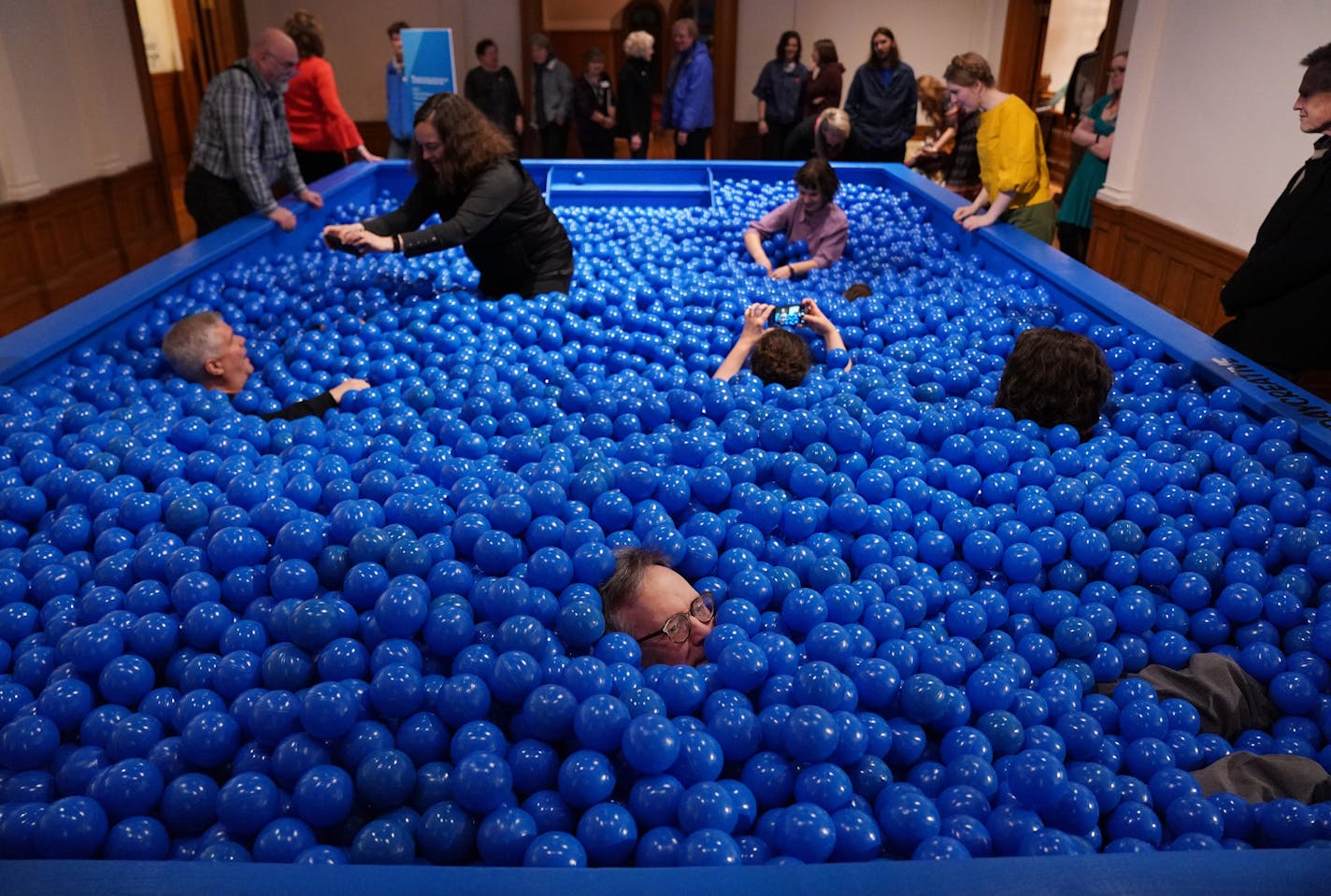 Guests both young and old played in a ball pit, set up in the American Swedish Institute's ballroom, during last weekend's opening party for "Extra/Ordinary."