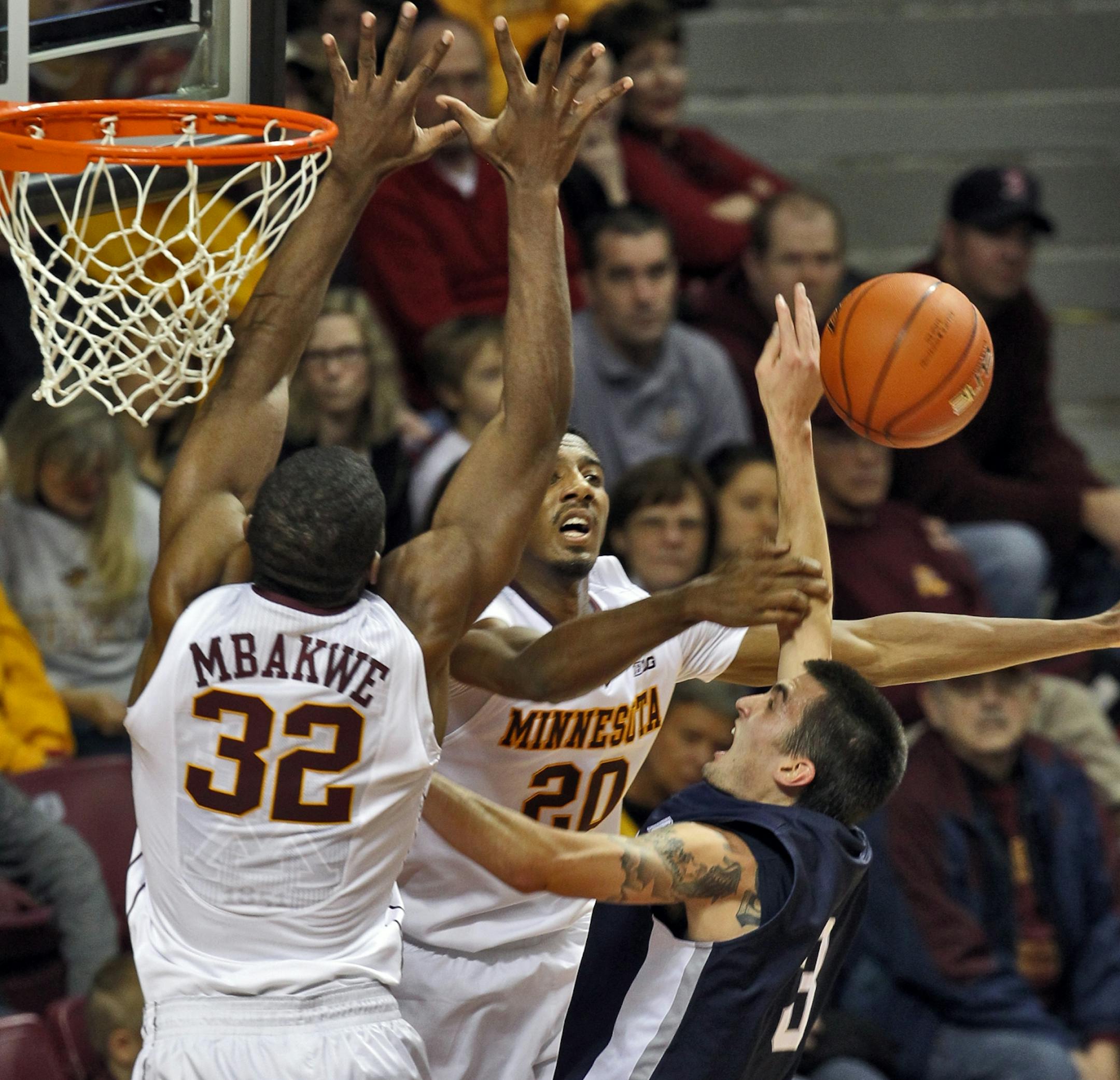 Gophers Trevor Mbakwe and Austin Hollins (20) put the defensive stop on North Florida's Parker Smith as he attempted a layup Saturday.