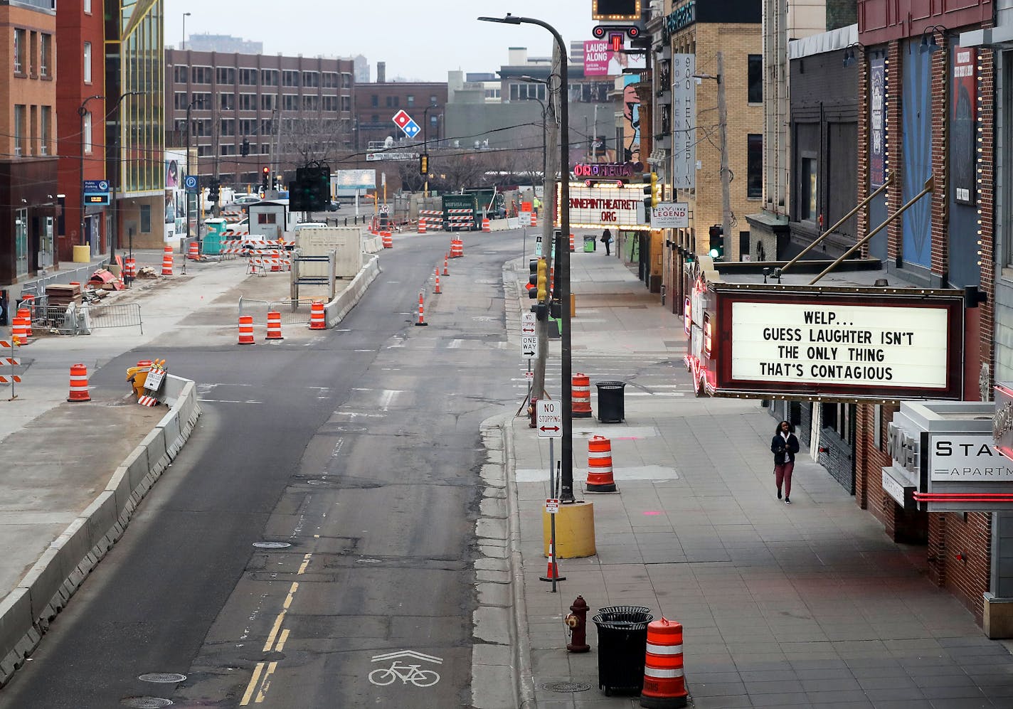 Two years ago, at the start of the pandemic lockdown, traffic in the theater district was light as the marquee message above Brave New Workshop on Hennepin Avenue offers a light message in the face of the coronavirus pandemic.