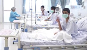 In this image made from video, released by the Thailand Government Spokesman Bureau, three of the 12 boys are seen recovering in their hospital beds a