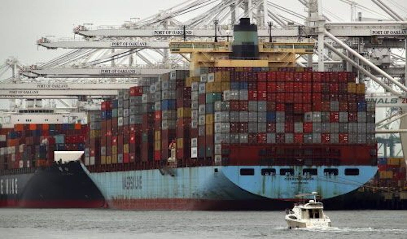 Container ships wait to be unloaded at the Port of Oakland on Monday, July 2, 2018, in Oakland, Calif. The Trump administration on Friday, July 6, 2018, started imposing tariffs on $34 billion in Chinese imports.