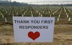 A sign thanking first responders hangs by a newly planted vineyard Monday in Napa, Calif.