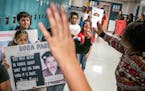 Third-graders at St. Paul's American Indian Magnet School held posters of people they picked for empowering others and marched through the hallways on