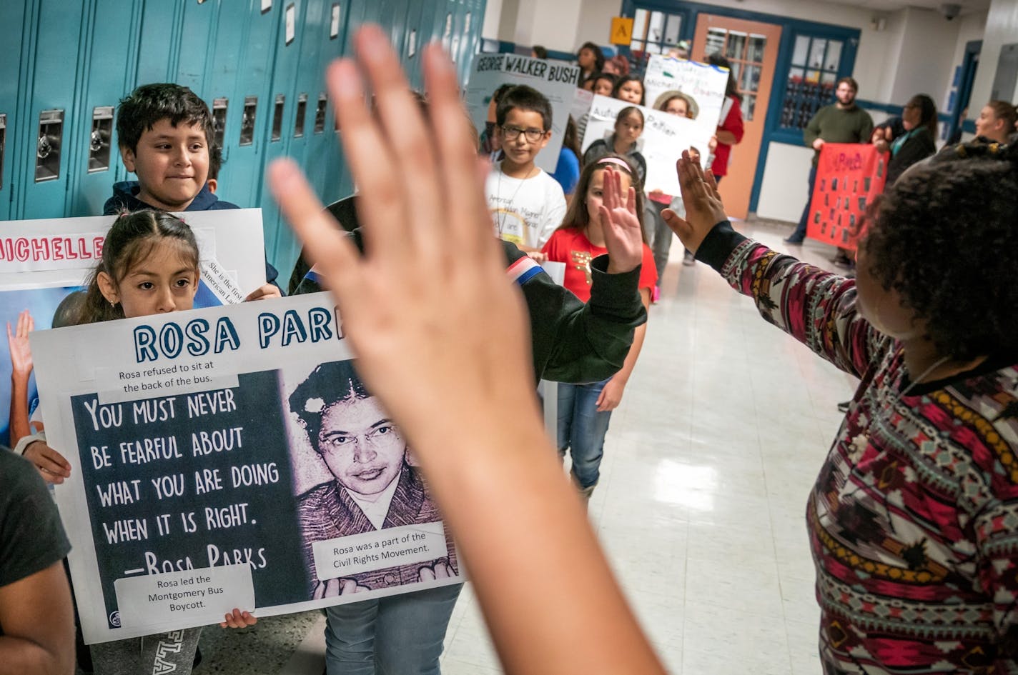 Third-graders at St. Paul's American Indian Magnet School held posters of people they picked for empowering others and marched through the hallways on Indigenous Peoples Day on Oct. 8, 2018.