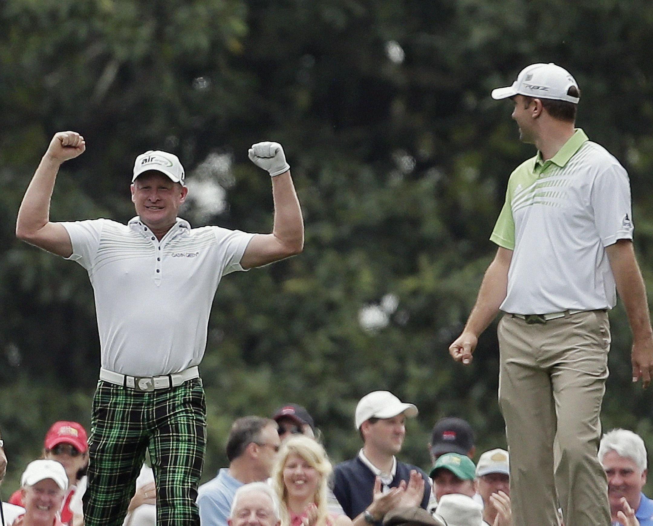 Martin Laird, right, watches as Jamie Donaldson, of Wales, celebrates after Donaldson's hole-in-one from the sixth tee during the first round of the Masters golf tournament Thursday, April 11, 2013, in Augusta, Ga. (AP Photo/Charlie Riedel)