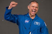 Anil Menon celebrates following an astronaut graduation ceremony Tuesday in Houston.