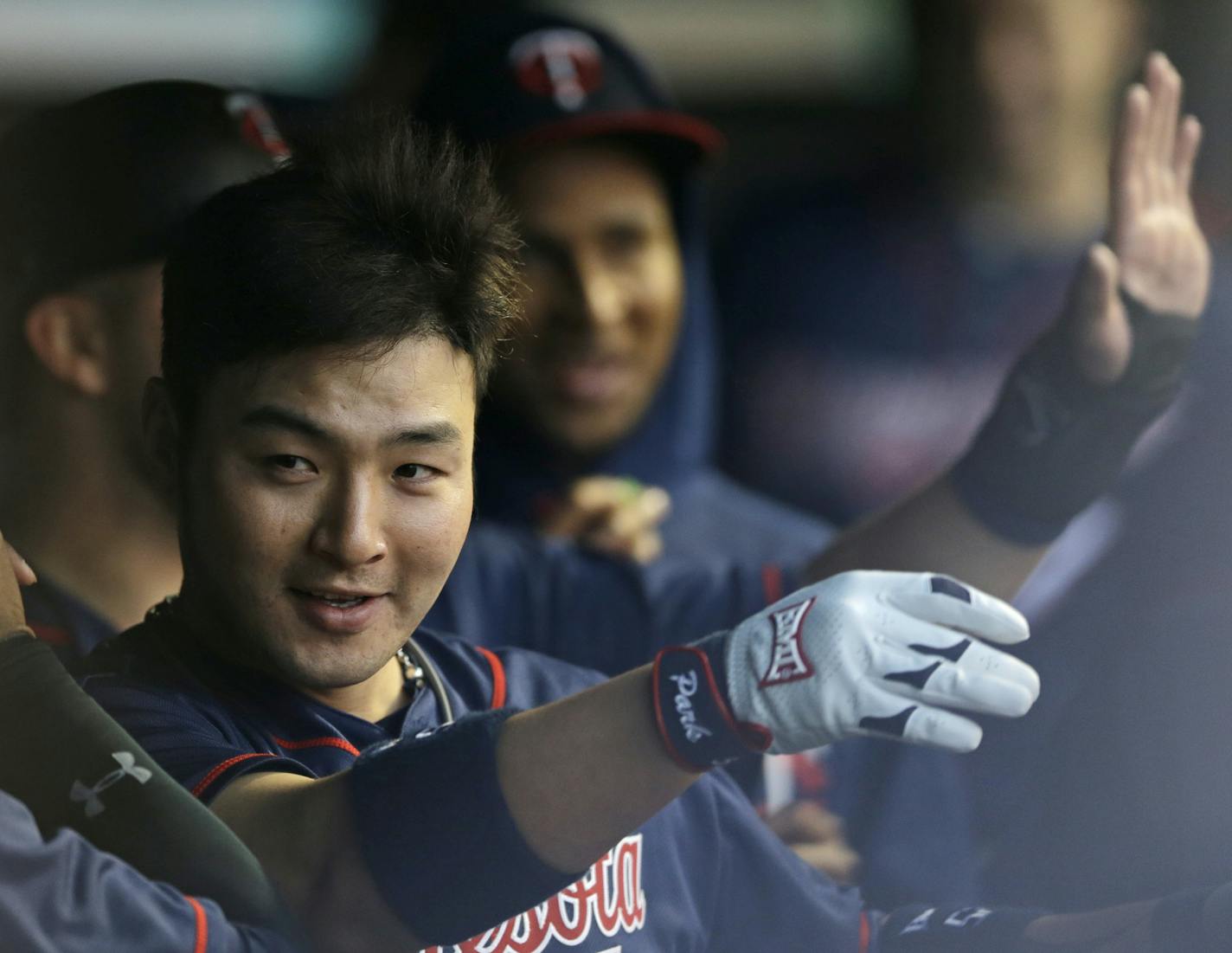 Minnesota Twins' Byung Ho Park celebrates with teammates in the dugout after hitting a two-run home run off Cleveland Indians starting pitcher Josh Tomlin during the third inning of a baseball game Friday, May 13, 2016, in Cleveland. (AP Photo/Tony Dejak)