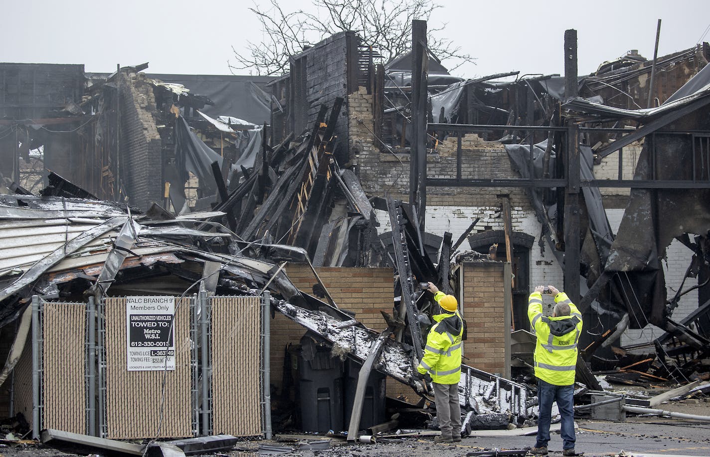 Building inspectors took cell phone photos of what remained of the fire that destroyed several businesses on the 2400 block of Central Avenue, Monday, March 23, 2020 in Minneapolis, MN. ] ELIZABETH FLORES &#x2022; liz.flores@startribune.com