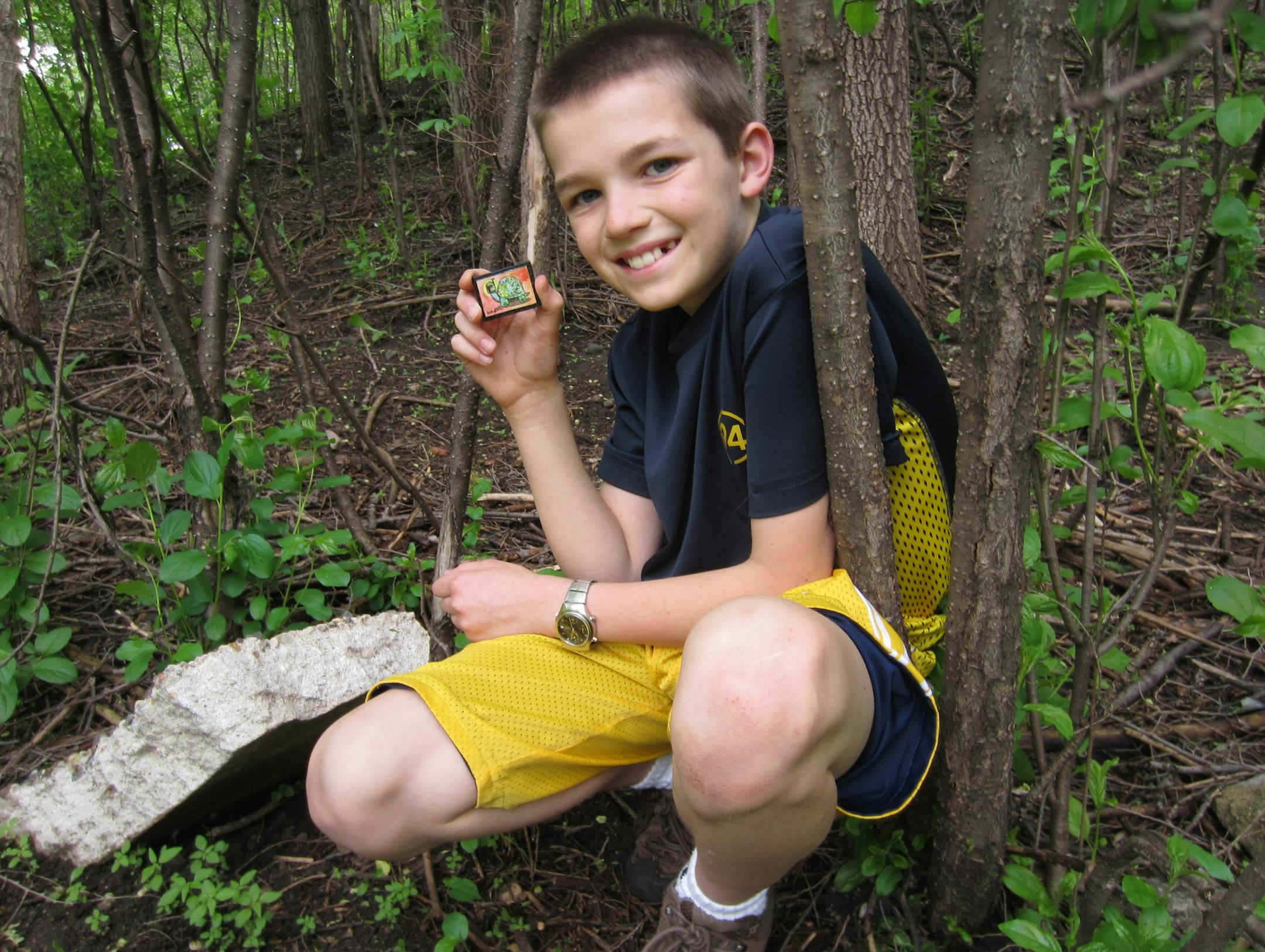 Louis Weinrich and his father Kevin Weinrich went to eight parks to search for Hessian's miniature art. They found this one under a rock at Sunset Park .