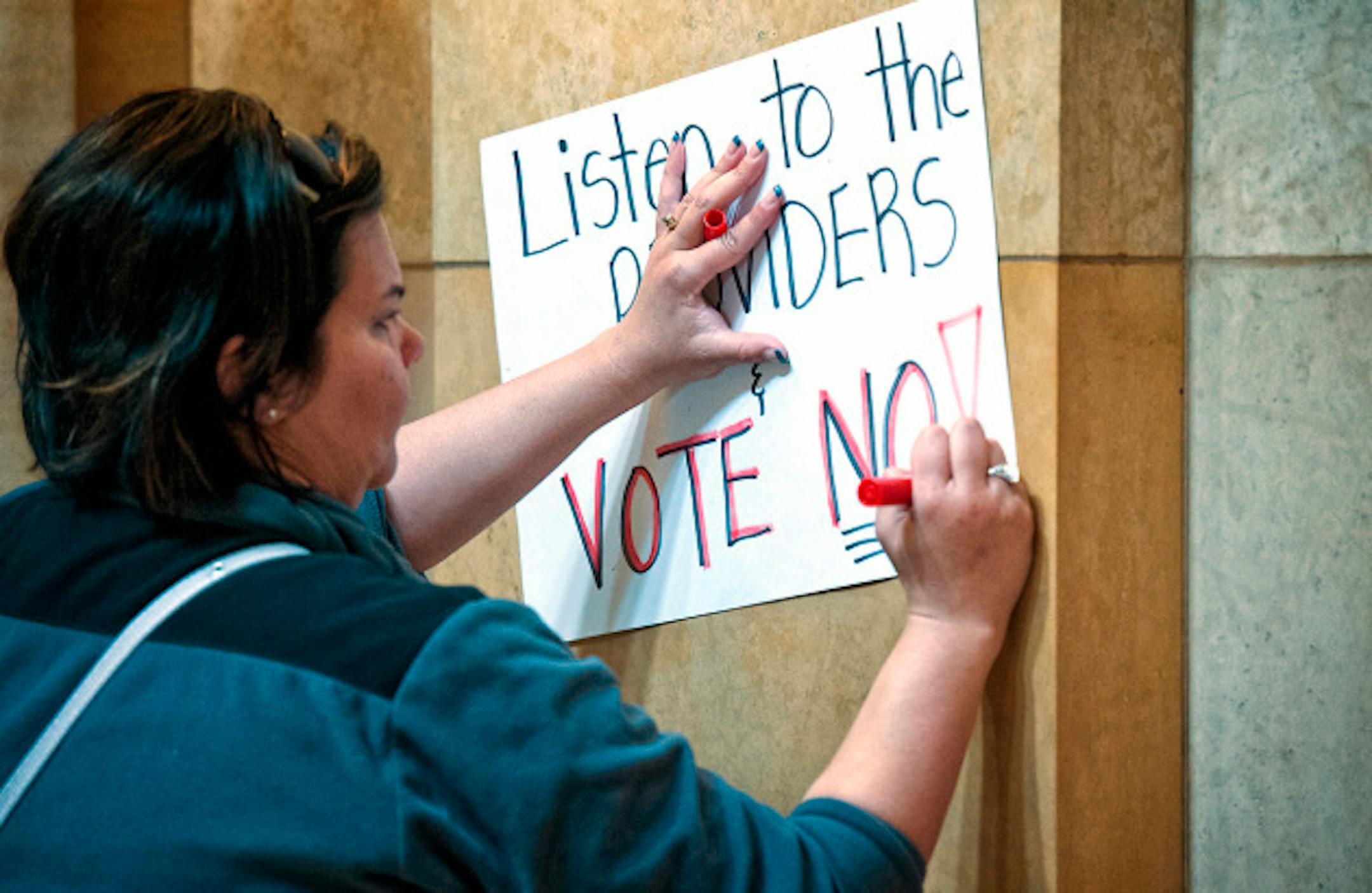 Carri Speikers from Jordan, made a sign urging legislators to vote no on a bill on unionization of at-home daycare workers,  Saturday, May 18, 2013  ]   GLEN STUBBE * gstubbe@startribune.com