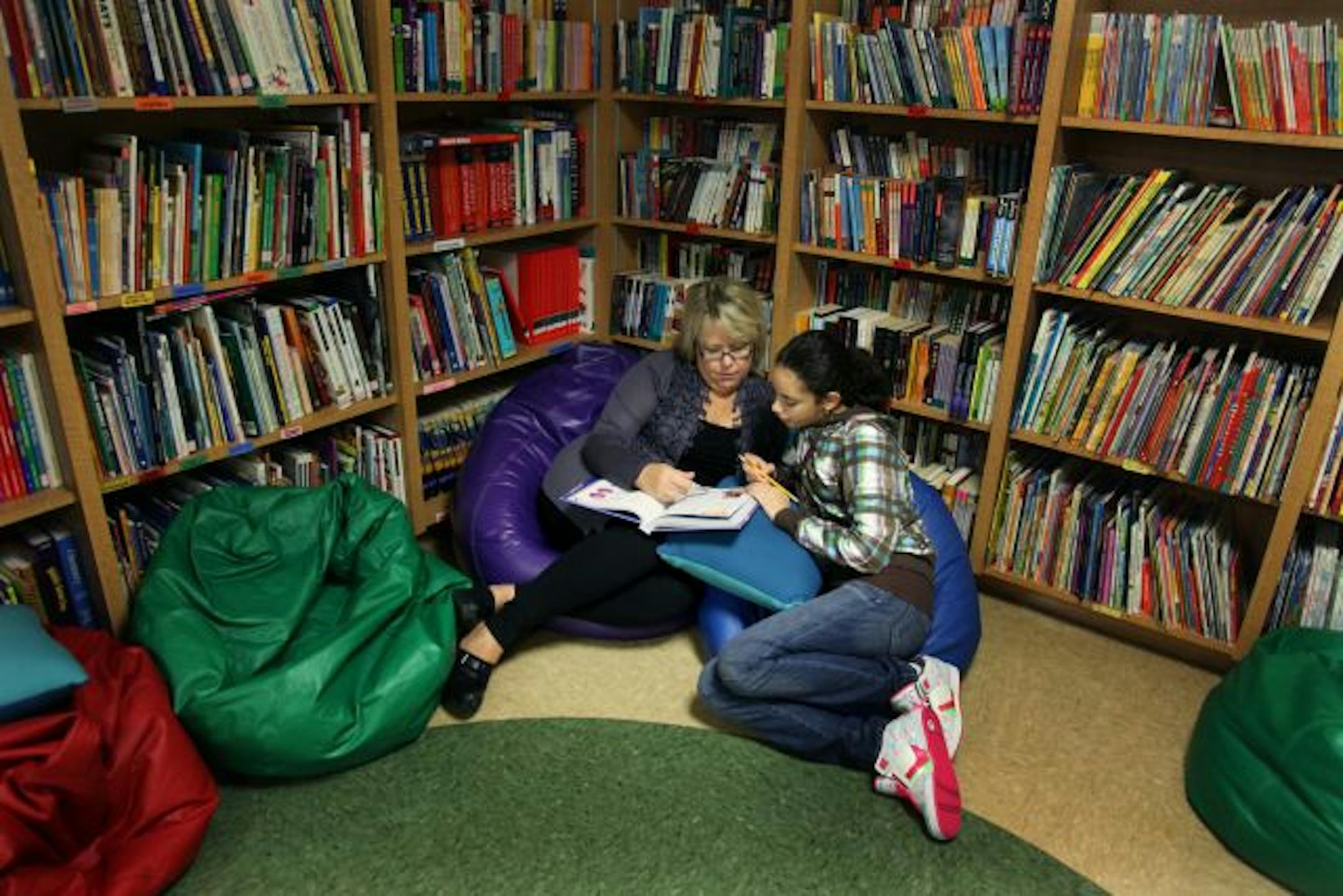 Teacher and director Cindy Britain, left, got comfortable with student Rowan Maamoun, 14, of Egypt. Maamoun has been attending the school since she was 8.