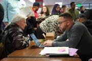 Patrick Ingram, First Ward credential co-chair, worked on getting residents registered at a DFL convention inside Central High School on Saturday. The