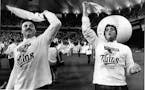 Tom Brunansky (at left) and Kent Hrbek (right) wave their Homer Hankies and enjoy the homecoming celebration at the Humphrey Metrodome for the Minneso
