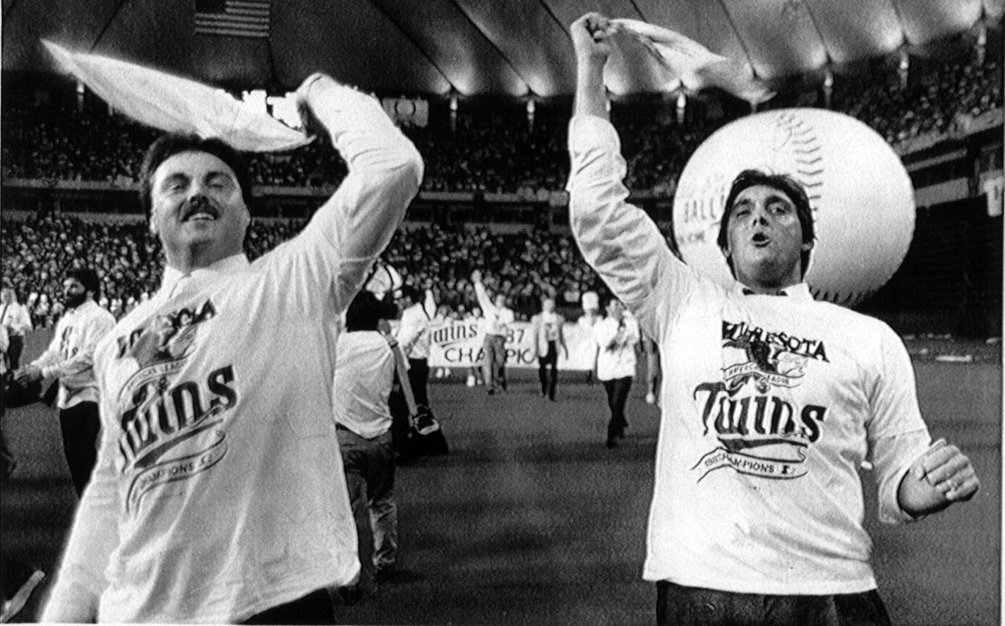 Tom Brunansky (at left) and Kent Hrbek (right) wave their Homer Hankies and enjoy the homecoming celebration at the Humphrey Metrodome for the Minnesota Twins, Monday Oct 12, 1987, after the Twins returned to town as the 1987 American League champs. Associated Press (AP) photo by Larry Salzman.