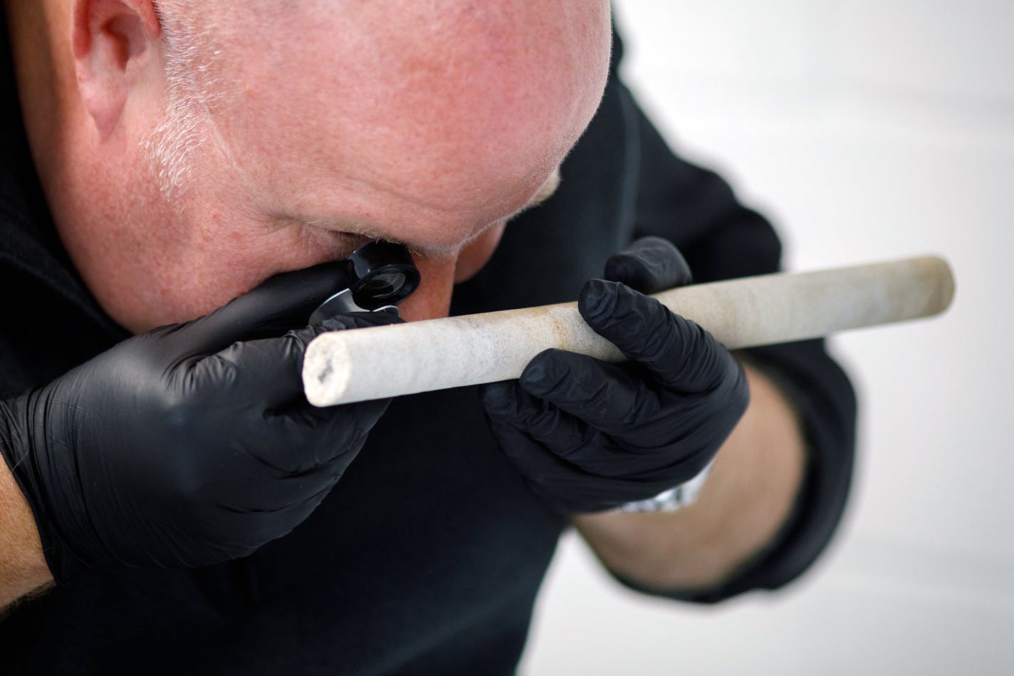 An undated photo provided by the charity English Heritage shows David Nash, a geomorphologist at the University of Brighton, examining a core from Stonehenge's Stone 58 that was stolen in the 1950s and was recently repatriated. (Sam Frost/English Heritage via The New York Times) -- NO SALES; FOR EDITORIAL USE ONLY WITH NYT STORY SLUGGED tktktktktk BY FRANZ LIDZ FOR JULY 29, 2020. ALL OTHER USE PROHIBITED. --