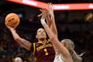 Gophers forward Ayianna Johnson drives toward the basket to attempt a layup against Michigan forward Chyra Evans in the first half.