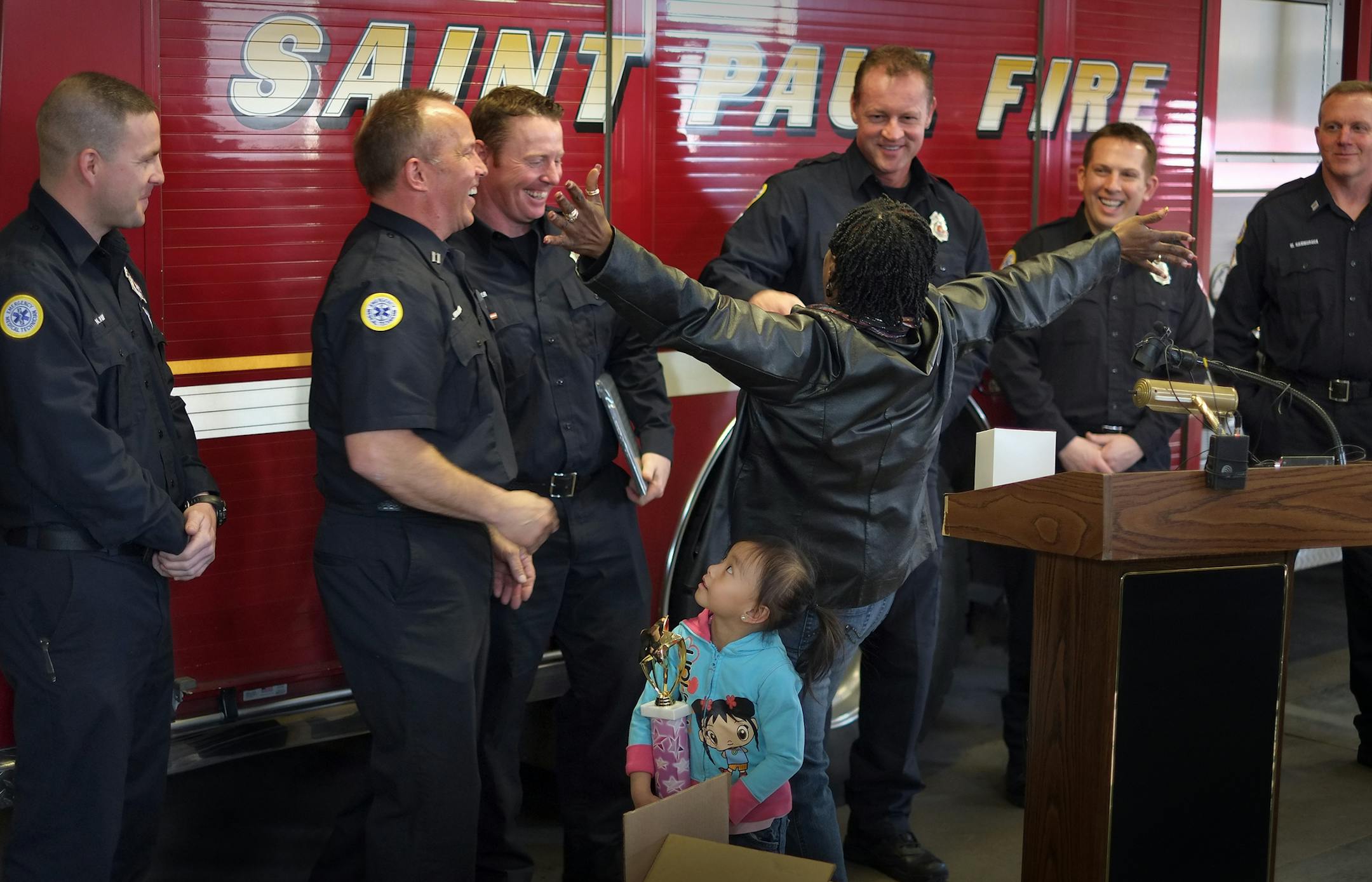 Janella Scott thanked St. Paul neighbors, firefighters and doctors for saving her daughter, Daphine, during a house fire in January. Daphine was home alone when a fire broke out in the family's St. Paul home. She was found unconscious, and had badly injured from smoke inhalation. from left, Nic Vars, Neil Youngblom, Jason Saver, Dan Pierskalla, Drew Pawlitschek, Mike Hamburger and Shayna Yang, 5, who persistence led to the rescue.. STAR TRIBUNE/TOM WALLACE Assignments #20028368A March 30, 2013 E