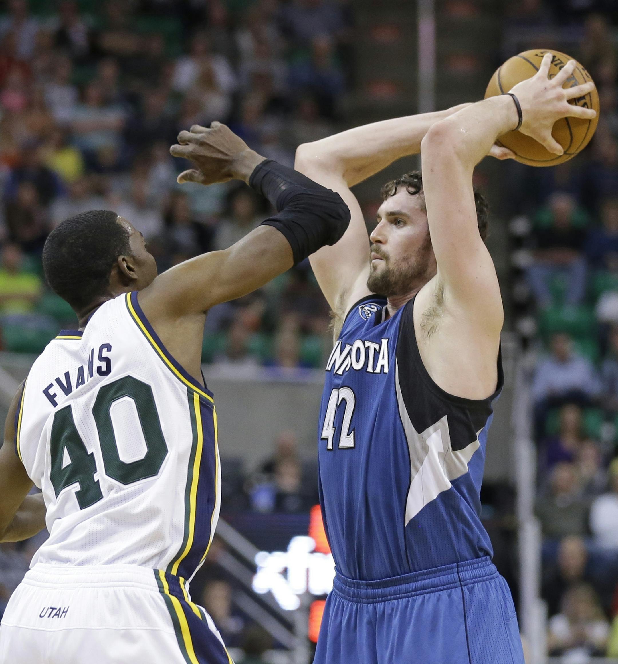 Utah Jazz's Jeremy Evans (40) guards Minnesota Timberwolves' Kevin Love (42) in the second half of an NBA basketball game Saturday Feb. 22, 2014, in Salt Lake City. (AP Photo/Rick Bowmer)
