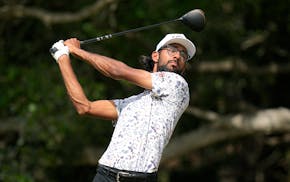 Akshay Bhatia watches his tee shot on the 14th hole during the third round of the Texas Open