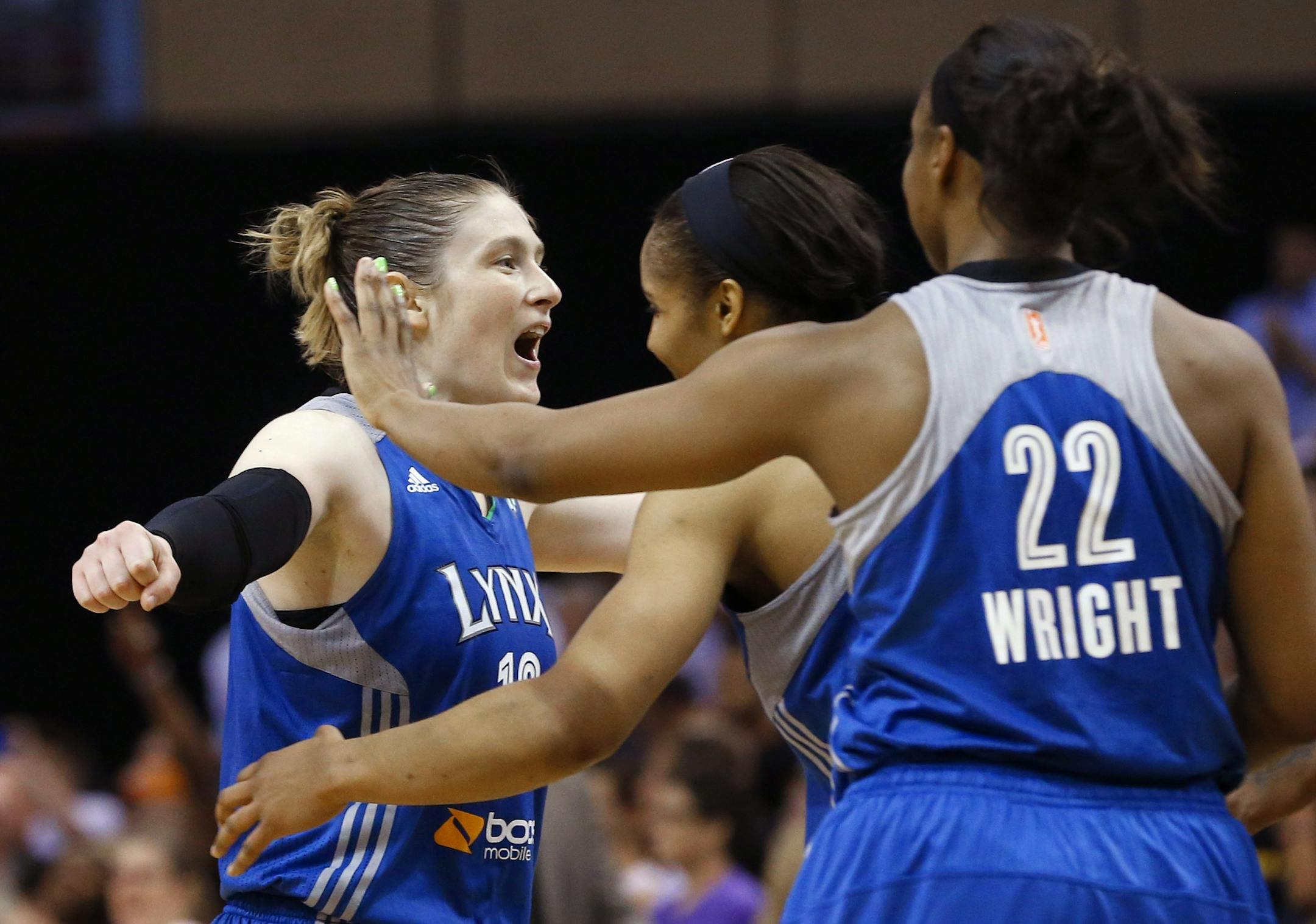Lindsay Whalen, left, celebrates a win over the Phoenix Mercury with teammates Monica Wright (22) and Maya Moore as time expires in a WNBA Western Conference Finals on Sunday, Sept. 29, 2013, in Phoenix.