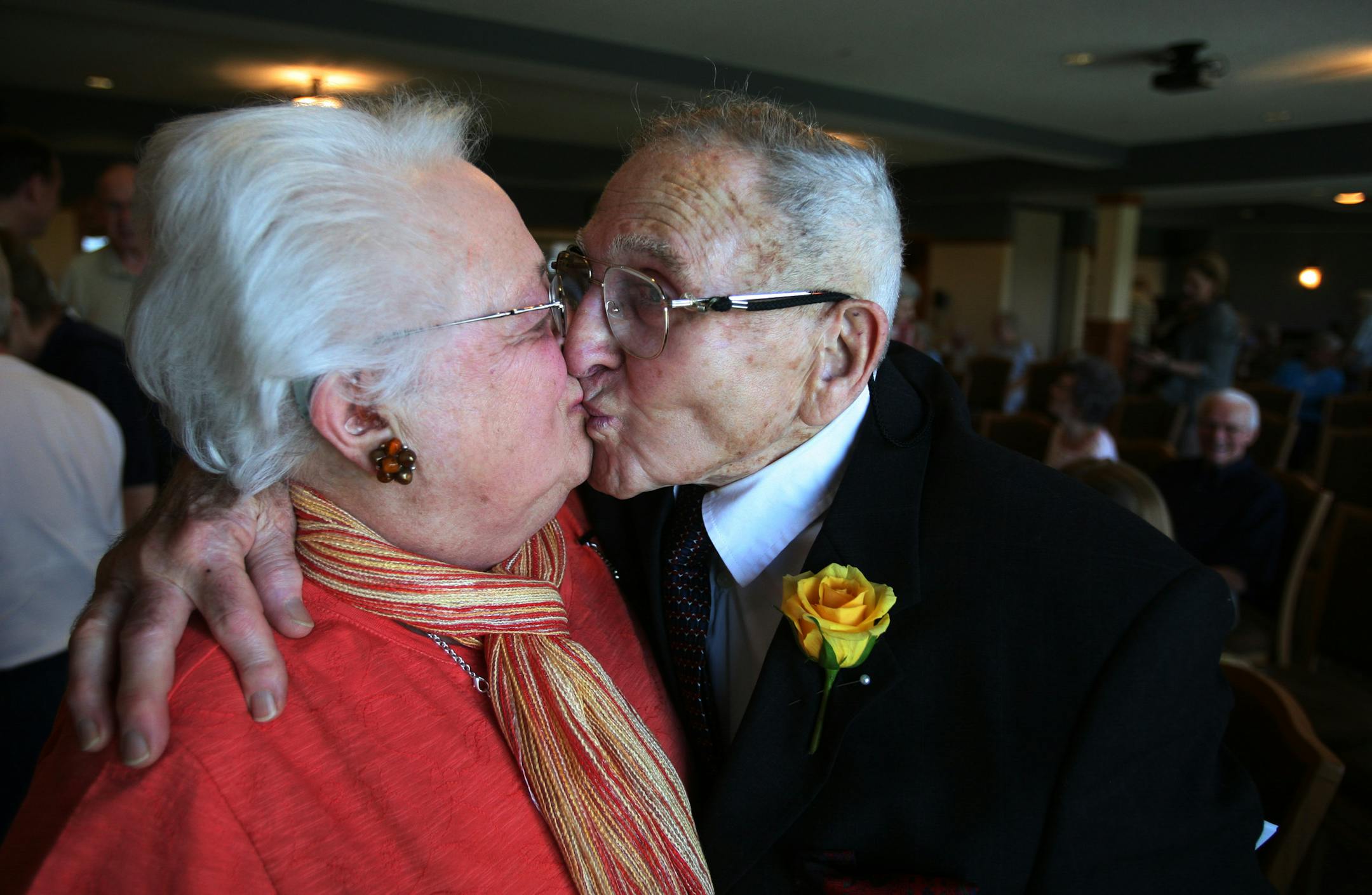 Henryk Gurman, 84, gave his wife, June Harvey, a kiss after he received an honorary teaching license from state Education Commissioner Alice Seagren on Monday. Gurman was two days from high school graduation when his family was hauled by boxcar to a gulag in Russia.