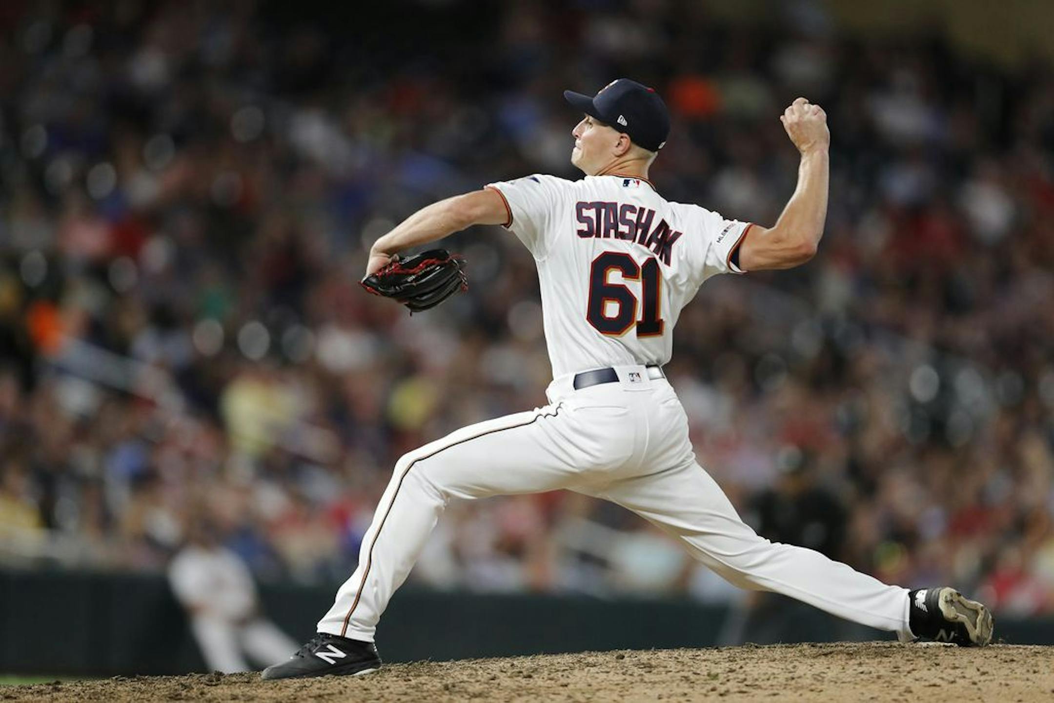 Minnesota Twins relief pitcher Cody Stashak (61) pitches in the seventh inning.