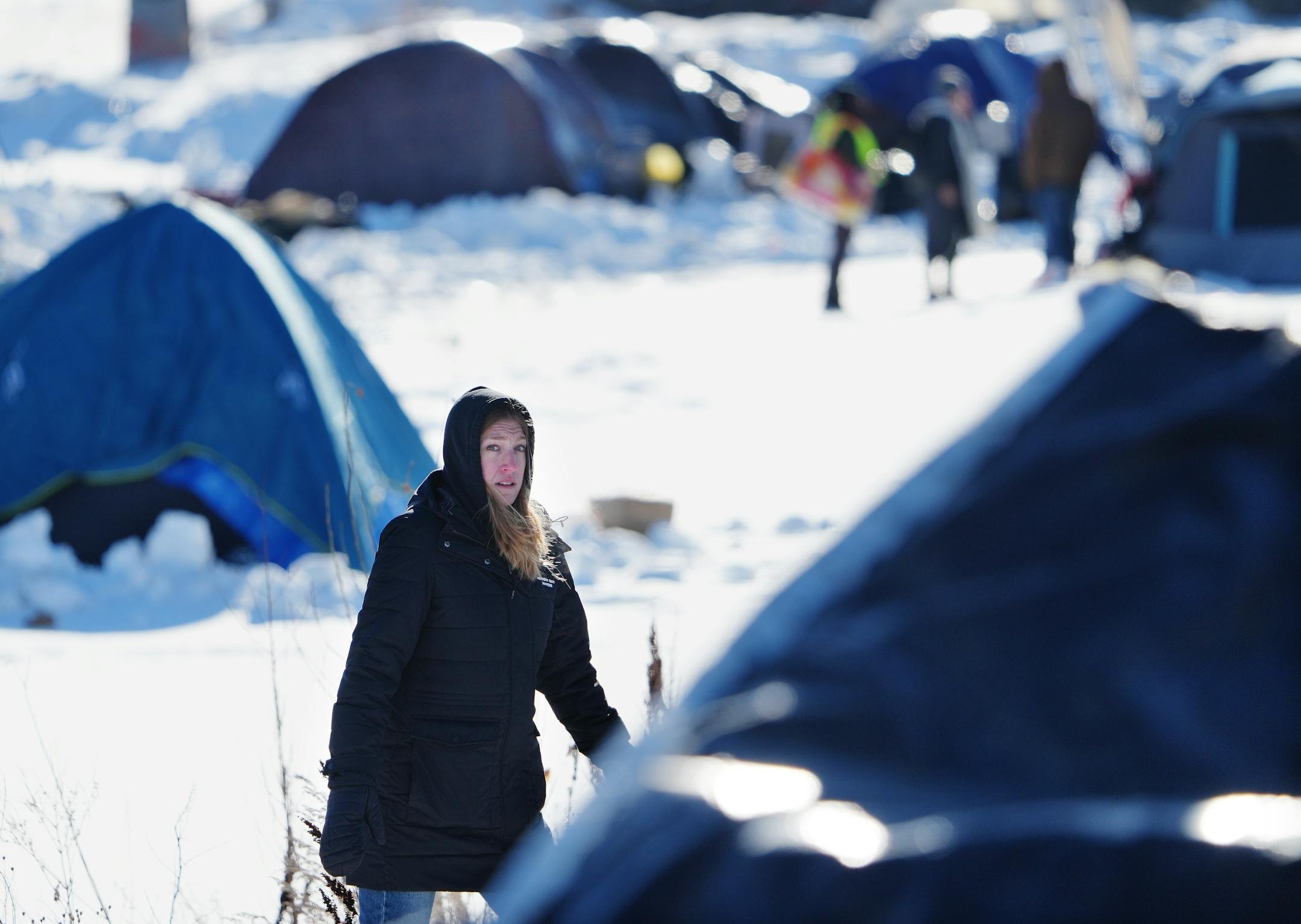 Mim Buckland of the Hennepin County Streets 2 Housing program looks for residents of a homeless encampment off of the 3000 block of Snelling Avenue, near Hiawatha Ave., as part of Hennepin County's "Point in Time," count of homeless people Thursday, Jan. 26, 2023 in Minneapolis.