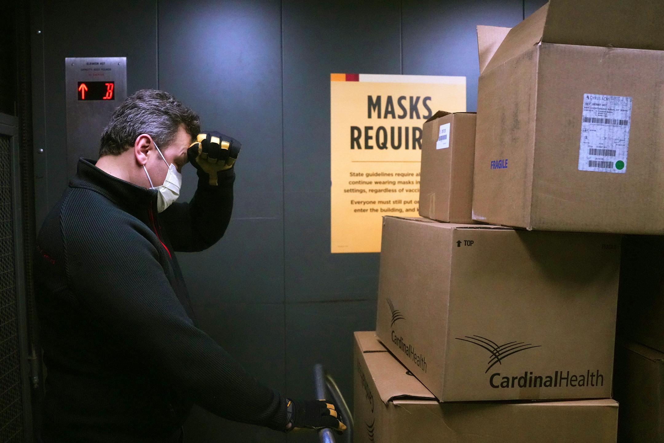 Mykola Sarazhynskyy, a volunteer with Stand with Ukraine MN, wipes sweat from his brow as he carts boxes of surplus medical supplies from the basement of M Health Fairview Masonic Children's Hospital to be sent to hospitals in Ukraine.