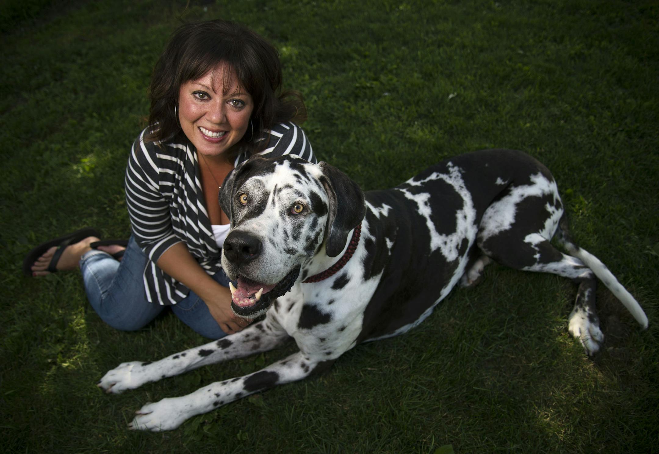 From left, Sara Popple posed with her dog Schatzi, a great dane, in her backyard in Rosemount, Minn., on Thursday July 23, 2015. Schatzi is seven years old and has donated blood 22 times. ] RACHEL WOOLF · rachel.woolf@startribune.com