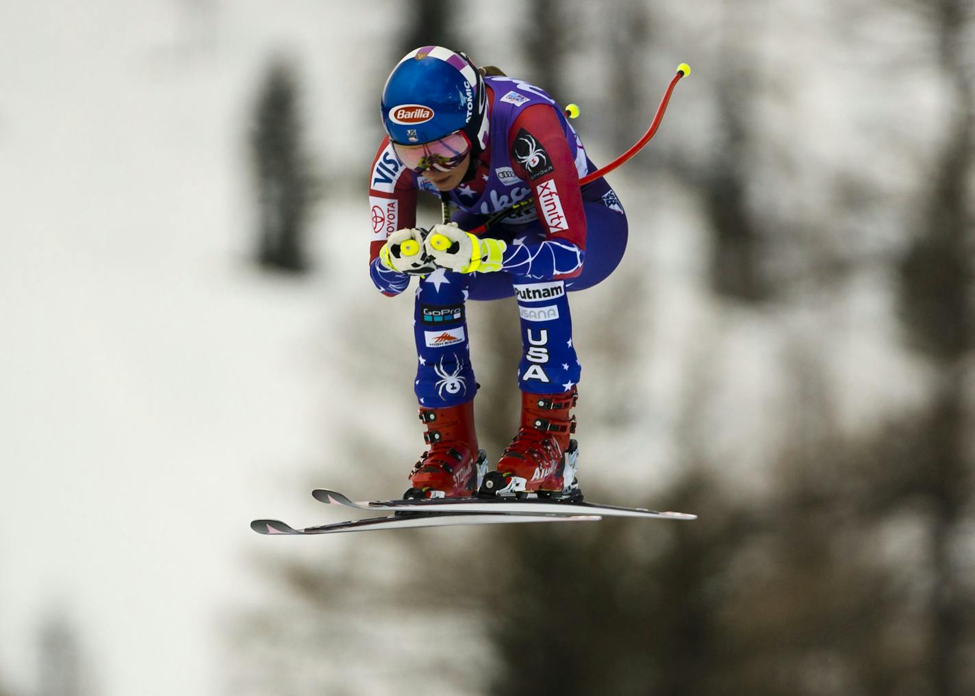 United States' Mikaela Shiffrin goes airborne to place third in an alpine skiing, women's World Cup downhill in Cortina d'Ampezzo, northern Italy, Friday, Jan. 19, 2018. Shiffrin clocked the third fastest time of 1 minute and 37.29 seconds. (AP Photo/Domenico Stinellis)