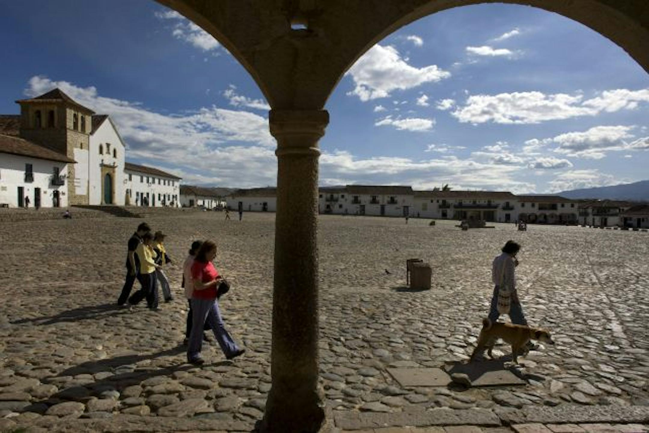 The Plaza Mayor in Villa de Leyva, a mountain-valley town founded by the Spanish in 1572, is notable for its unadorned vastness in Colombia in October 2009. One of the largest town squares in South America, the Plaza Mayor lacks the decorative playfulness of so many of its smaller siblings in Colombia and elsewhere, with only the paving stones giving it shape and form. But as the sun begins to drop down toward the nearby mountains, the plaza can quietly dazzle. Like the plaza that defines it, th