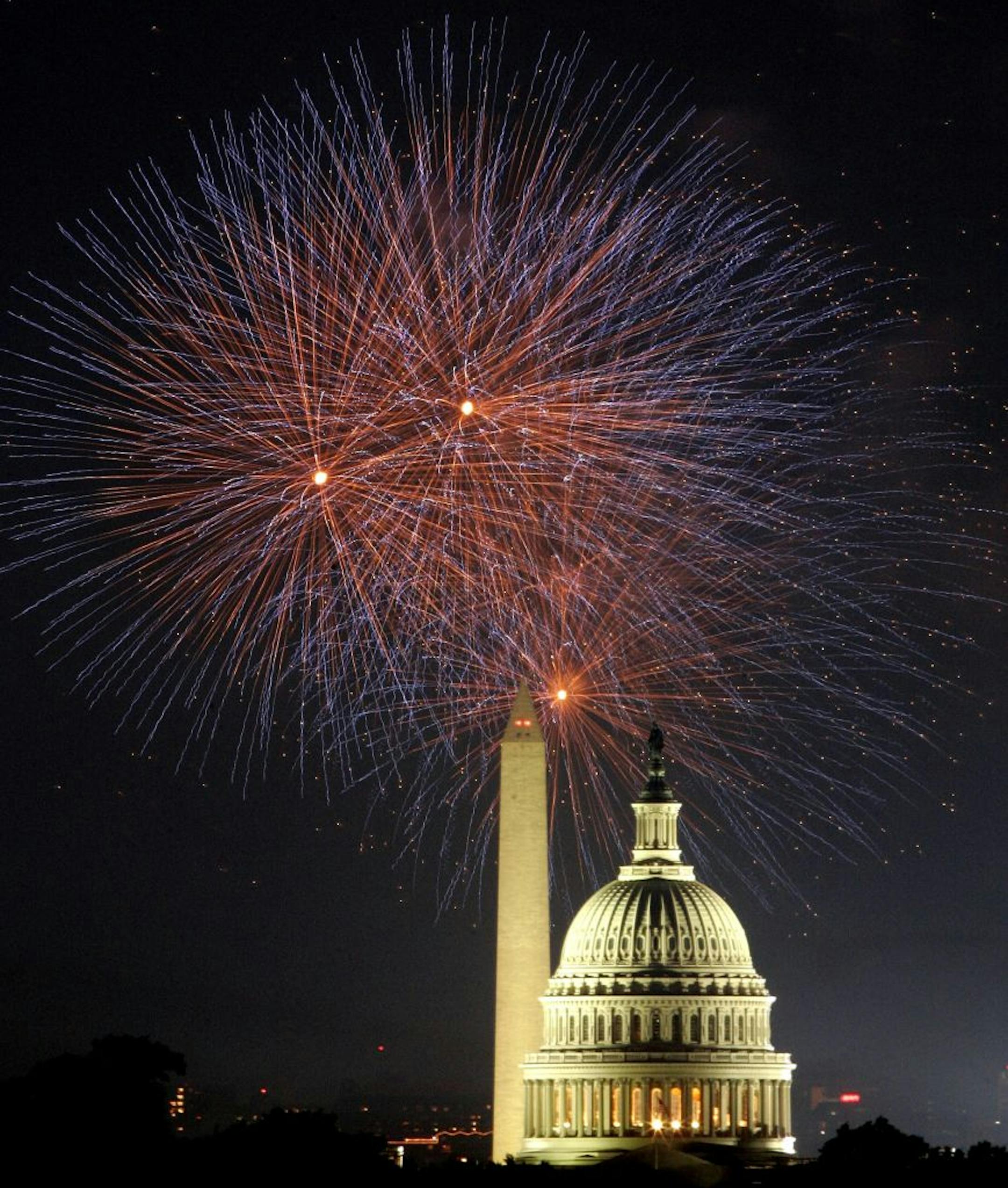WASHINGTON - JULY 4: Fireworks explode in the sky above the Washington Monument and the U.S. Capitol as the nation celebrates its 229th birthday July 4, 2005 in Washington, DC. Hundreds of thousands of people took part to celebrate the anniversary of the adoption of the Declaration of Independence in the nation's capital which concluded with the largest fireworks display in the area.