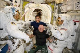In this photo provided by NASA, Boeing Crew Flight Test astronauts Suni Williams and Butch Wilmore, center, pose with Expedition 71 Flight Engineers M