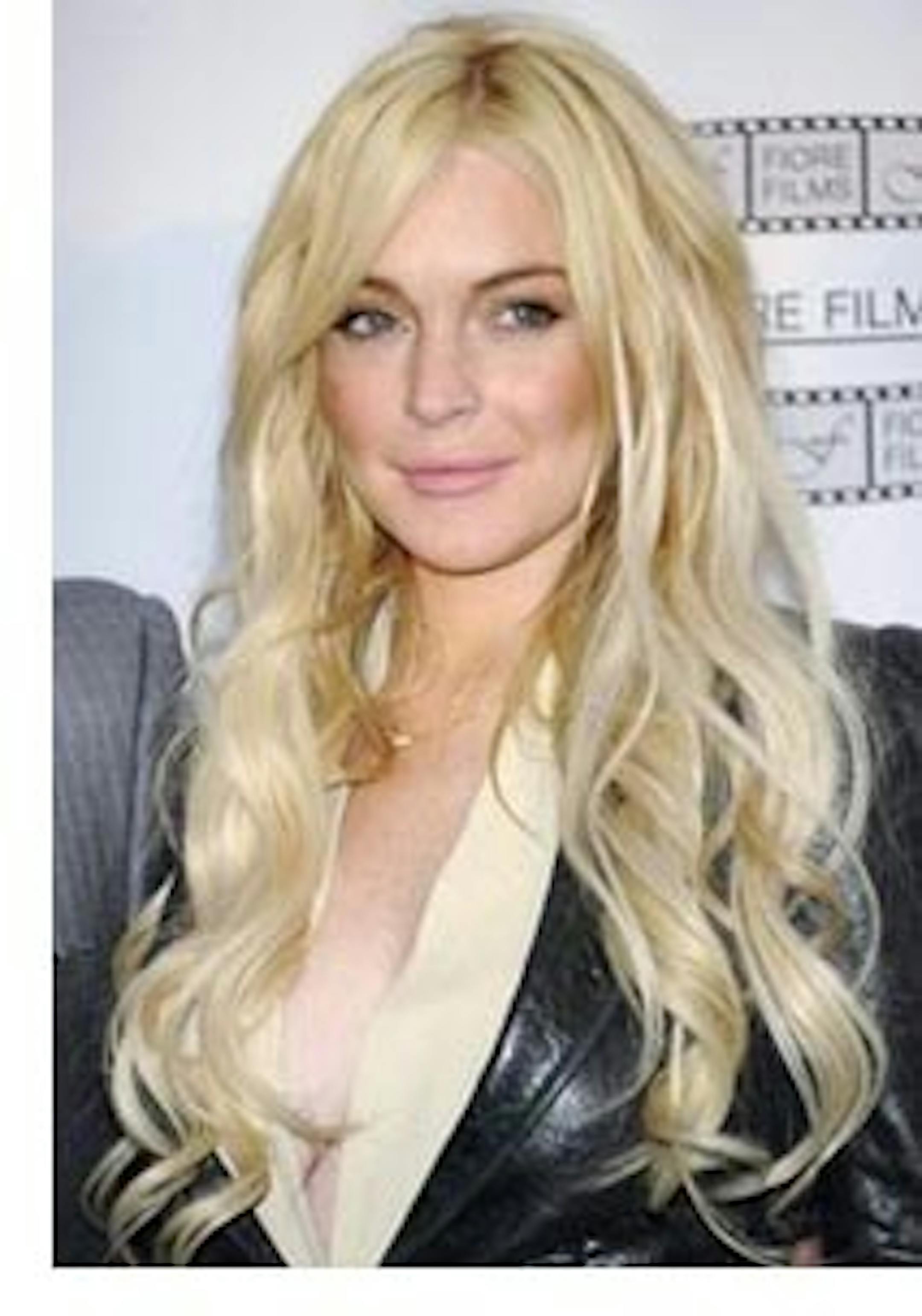 FILE - In this April 12, 2011 file photo, actress Lindsay Lohan poses during a news conference for the film "Gotti: Three Generations", based on the life of John Gotti, in New York. Lohan was released from house arrest after serving 35 days for a probation violation. (AP Photo/Evan Agostini, file)