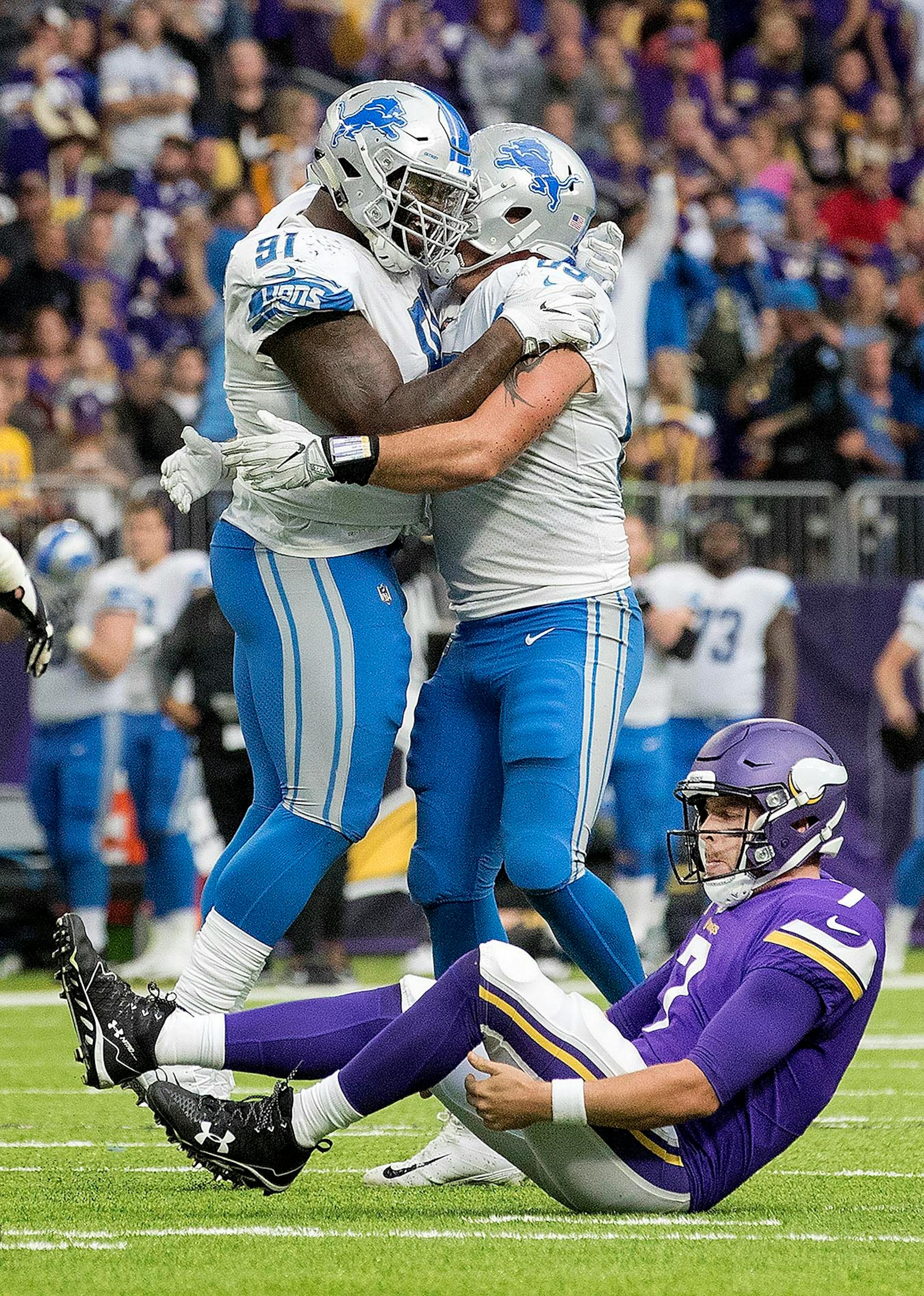 Minnesota Vikings Case Keenum (7) got up after being sacked by Anthony Zettel (69) in the fourth quarter. Lions AíShawn Robinson and Anthony Zettel (69) celebrated in the background.