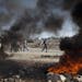 Palestinian burn tires during clashes with Israeli security forces after the funeral of Palestinian-American, Orwah Hammad, 14, who was shot dead last