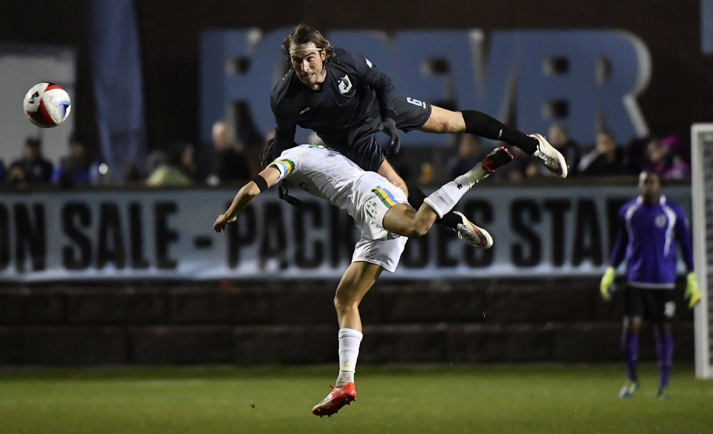 Minnesota United FC defender Brent Kallman (top)