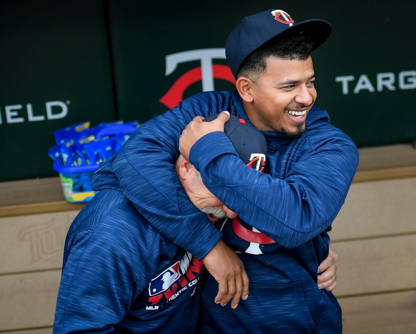 Minnesota Twins third baseman Eduardo Escobar (5) put conditioning coach Perry Castellano in a head lock as they joked around before the start of Tuesday night's game against the Houston Astros.