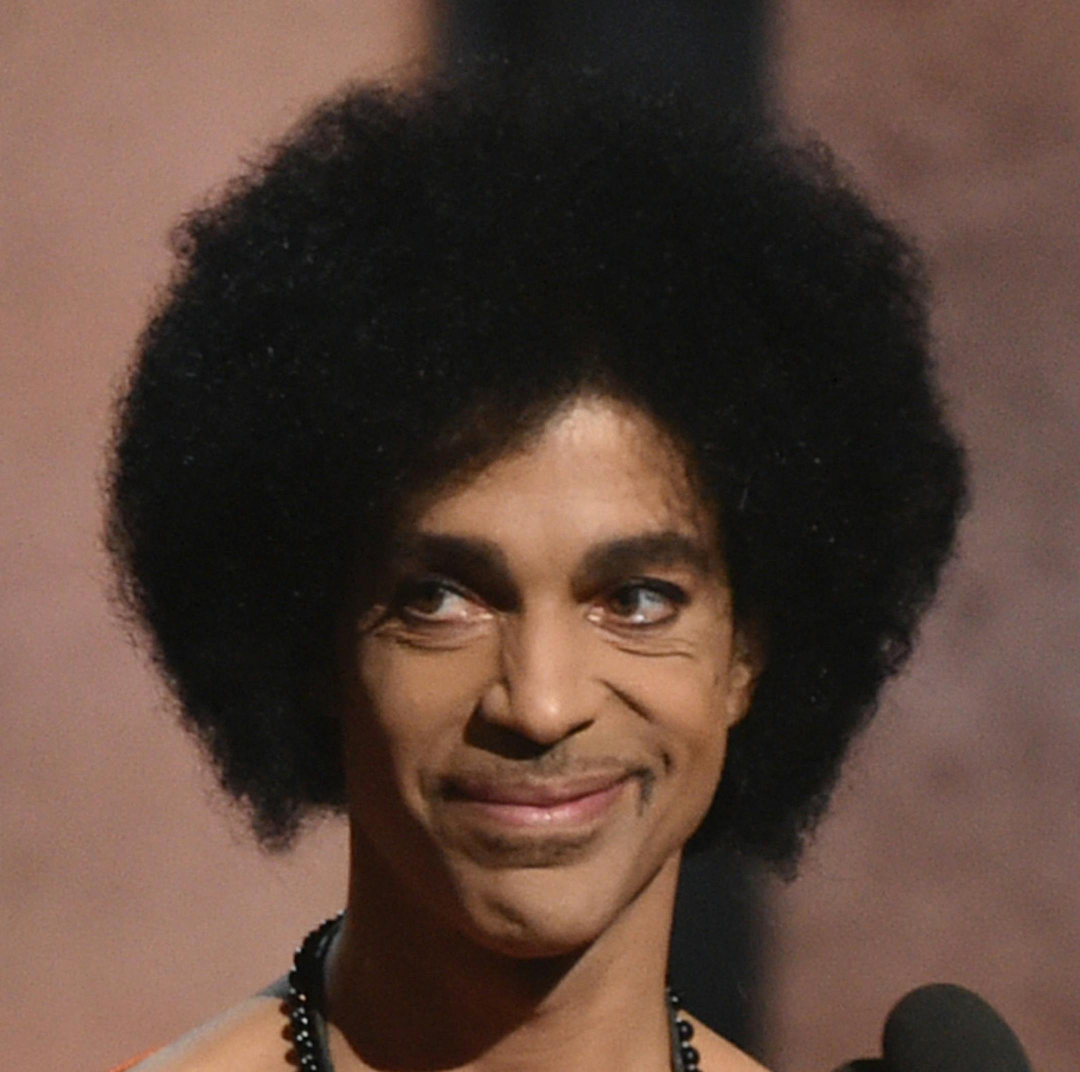 Prince presents the award for album of the year at the 57th annual Grammy Awards on Sunday, Feb. 8, 2015, in Los Angeles. (Photo by John Shearer/Invision/AP)