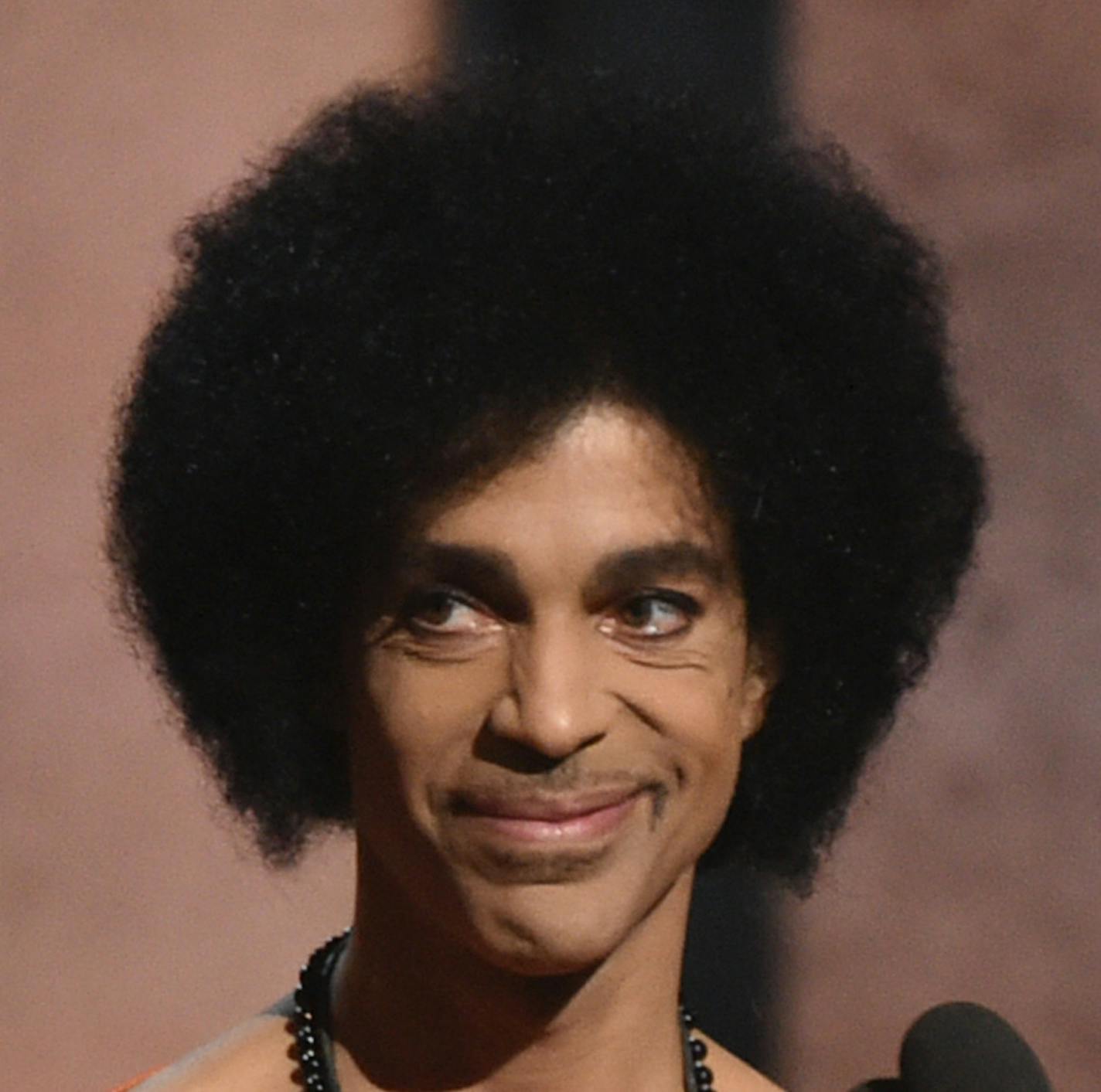 Prince presents the award for album of the year at the 57th annual Grammy Awards on Sunday, Feb. 8, 2015, in Los Angeles. (Photo by John Shearer/Invision/AP)