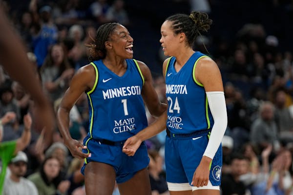 Lynx forward Napheesa Collier, right, celebrates with guard Diamond Miller after making a basket during a game June 27