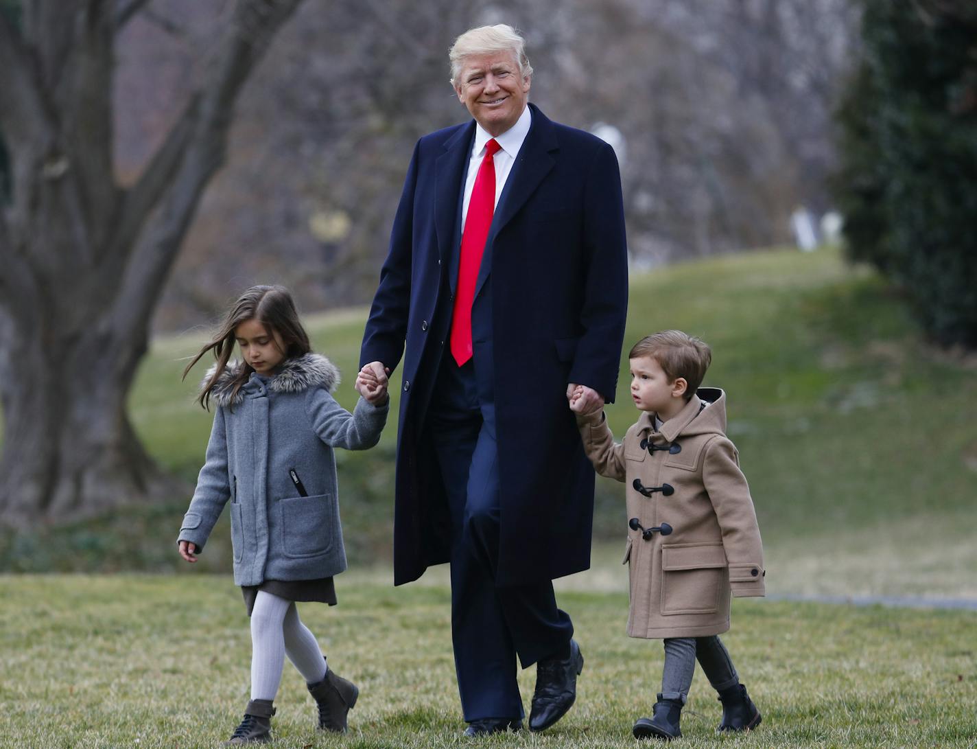 President Donald Trump walks with his grandchildren Arabella Kushner and Joseph Kushner to Marine One on the South Lawn of the White House in Washington, Friday, Feb. 17, 2017, for a short trip to Andrews Air Force Base, Md., then onto South Carolina and Florida. (AP Photo/Pablo Martinez Monsivais)