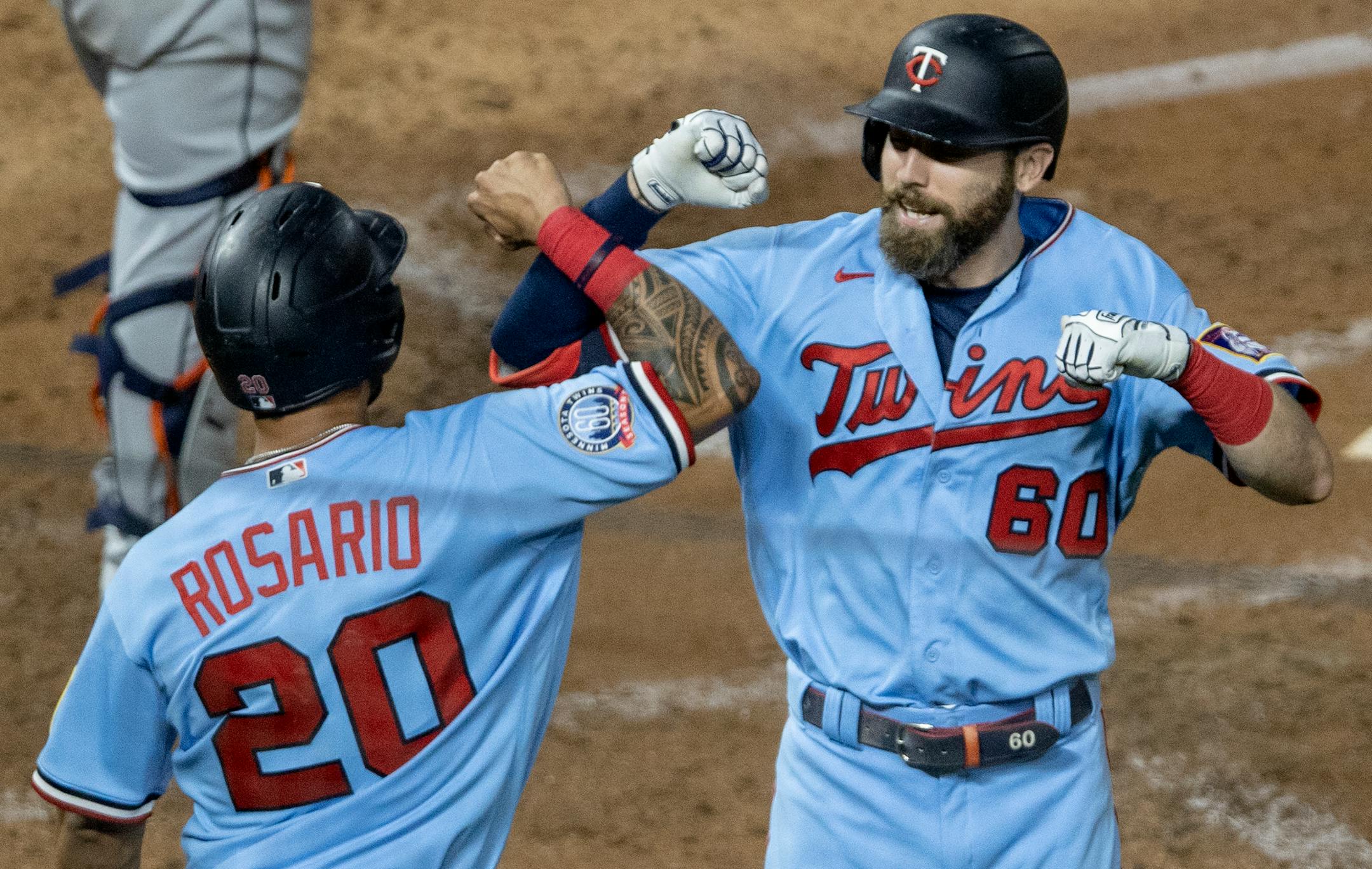 The Twins' Jake Cave (60) celebrated with Eddie Rosario (20) after hitting a home run in the fourth inning. Cave belted another in the sixth, and Rosario added one of his own in the fifth, as the Twins edged the Tigers 7-6 on Wednesday night.