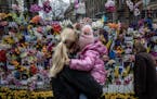 People visit a memorial for civilians killed during the Russian invasion of Ukraine, in Lviv, Ukraine, on April 24.