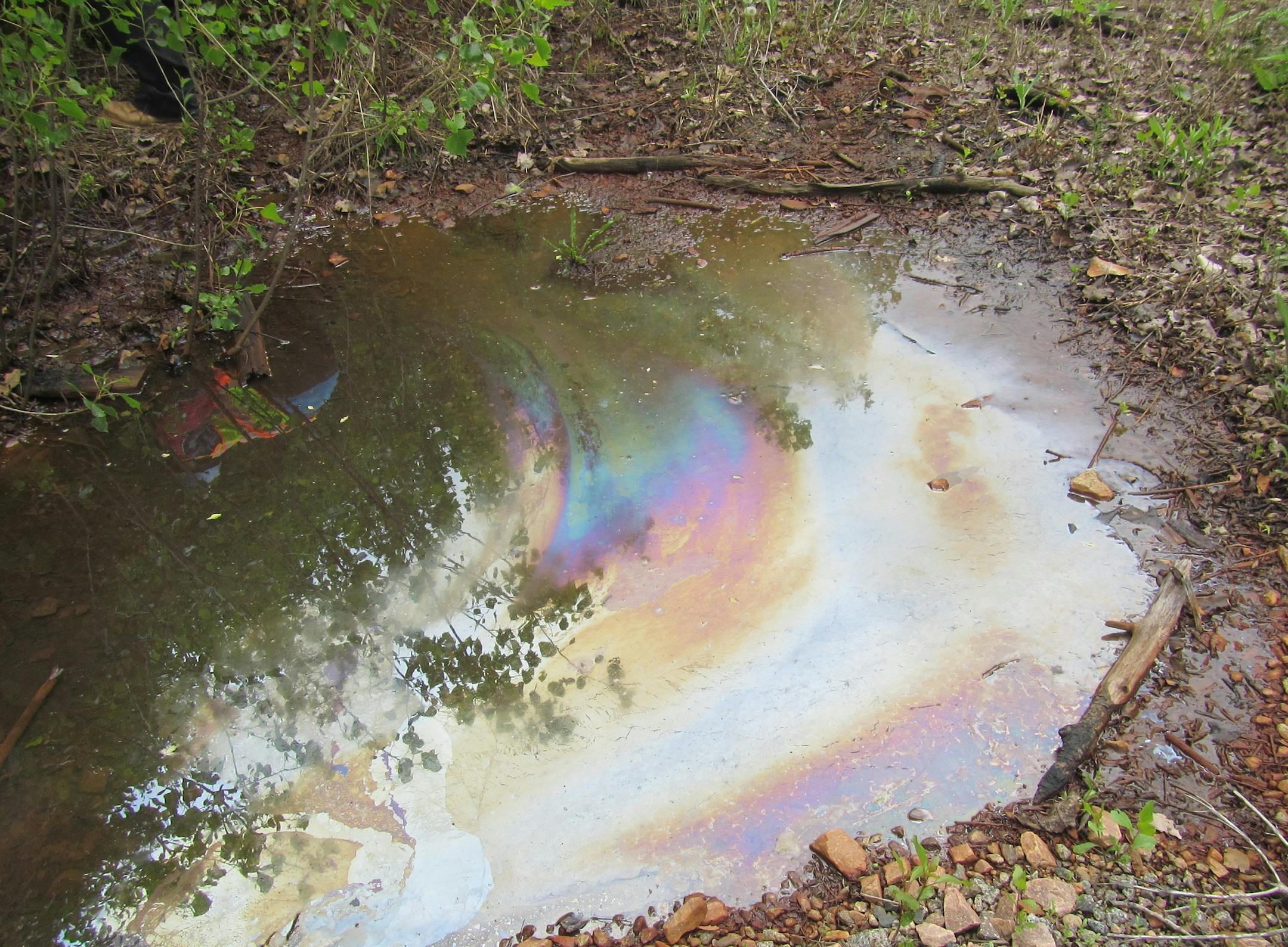 Oily discharge left a film atop standing water near Metro Metals.
