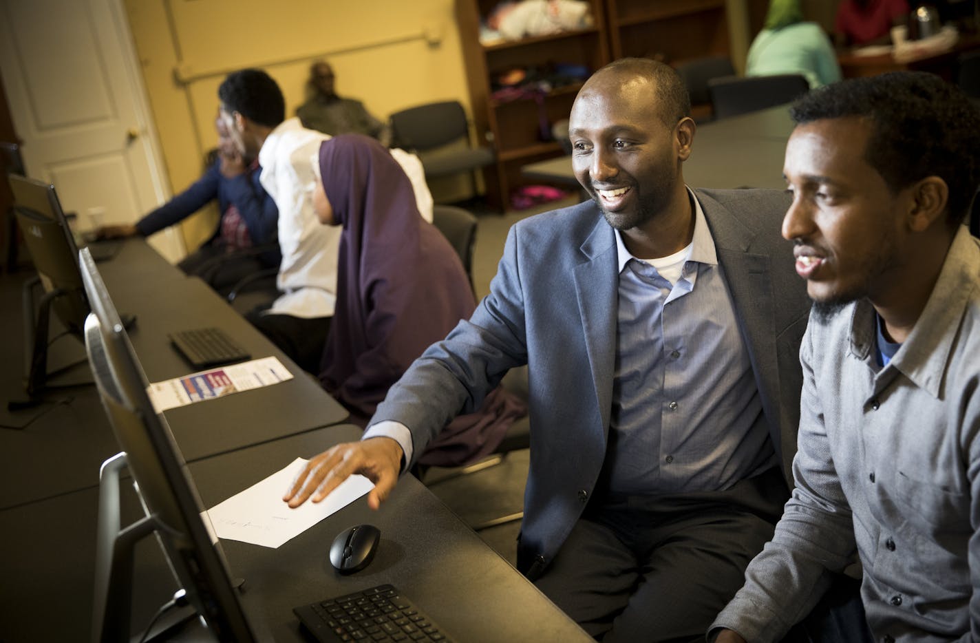 Mohamud Noor, left, helped Daud Abshir apply for a job at Amazon on Wednesday, October 19, 2016, in Minneapolis, Minn. ] RENEE JONES SCHNEIDER &#x2022; renee.jones@startribune.com