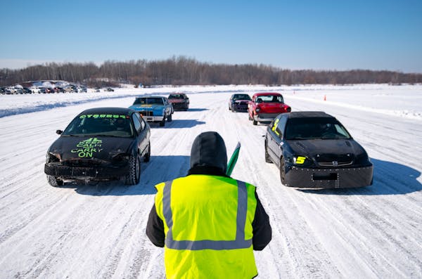 Craig Sheasby, one of the racing judges, lined up the cars on the starting line of the ice track before the start of one of the races on the Allouez B