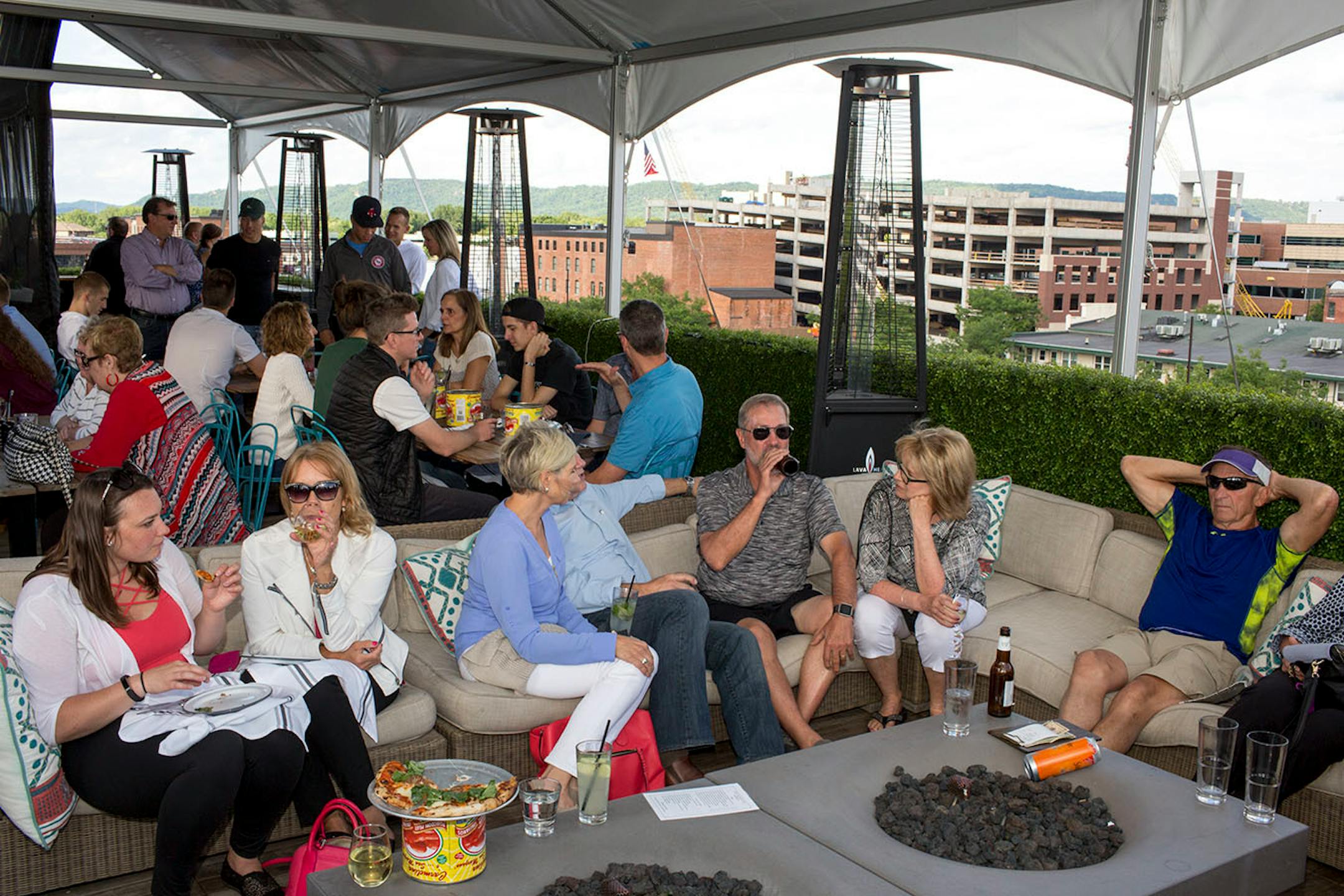 People enjoy the open-air rooftop patio at the Charmant Hotel in La Crosse. ] COURTNEY PEDROZA • courtney.pedroza@startribune.com June 22-24, 2017; Wisconsin restaurants, cafes, bars, bakeries and breweries; Dining along the Mississippi River.